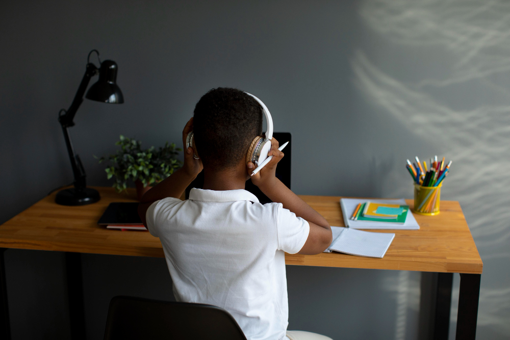 little-boy-listening-his-teacher-through-headphones